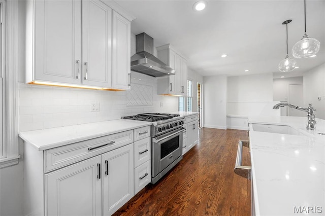 1304 Brynnwood Dr, Saint Louis, MO 63124 - kitchen featuring a sink, high end range, wall chimney exhaust hood, dark wood-type flooring, and white cabinets