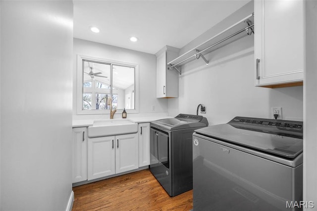 1304 Brynnwood Dr, Saint Louis, MO 63124 - laundry area featuring washer and clothes dryer, wood finished floors, cabinet space, and recessed lighting