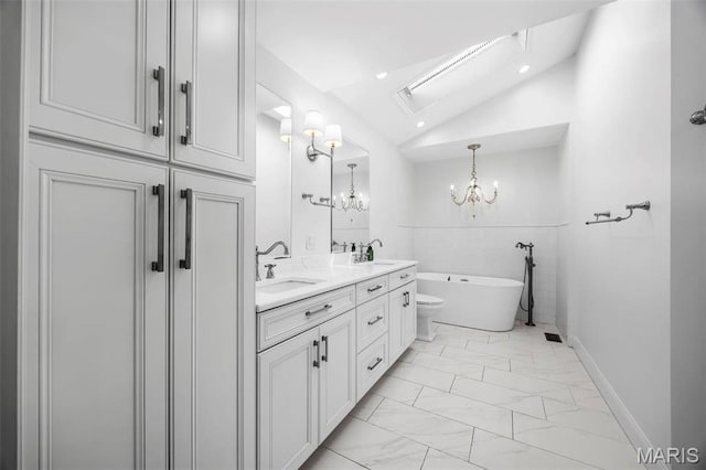 1304 Brynnwood Dr, Saint Louis, MO 63124 - full bath with marble finish flooring, a chandelier, a freestanding bath, vaulted ceiling, and double vanity