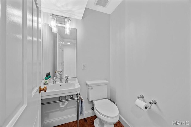 1304 Brynnwood Dr, Saint Louis, MO 63124 - half bathroom featuring toilet, wood finished floors, vanity, and baseboards