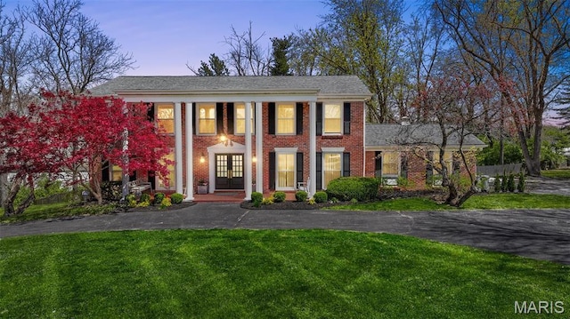 1304 Brynnwood Dr, Saint Louis, MO 63124 - greek revival inspired property featuring a yard, brick siding, and covered porch