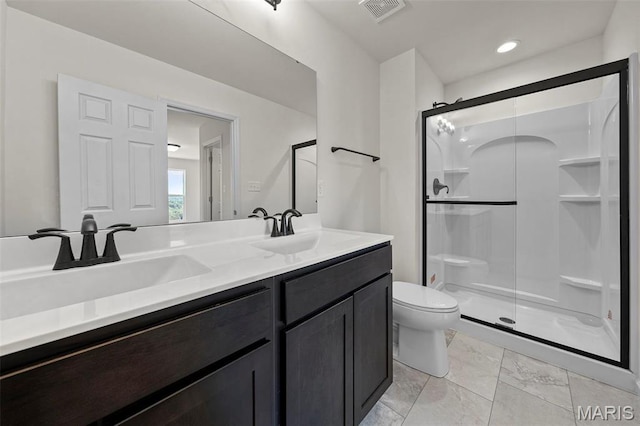 full bathroom featuring a shower stall, toilet, marble finish floors, and double vanity