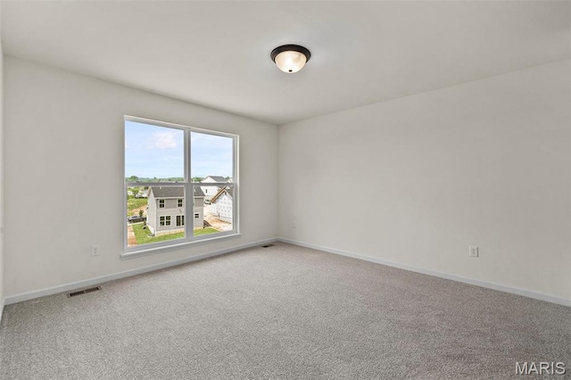 spare room with carpet floors and baseboards
