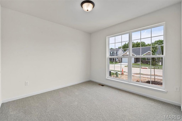 spare room with carpet flooring and baseboards