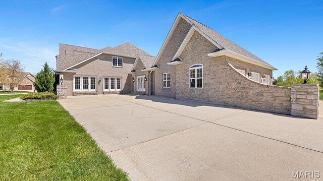 9108 Wiltshire Dr, Columbia, IL 62236 - rear view of house featuring a lawn, a patio, stone siding, and french doors