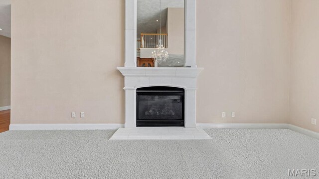 9108 Wiltshire Dr, Columbia, IL 62236 - unfurnished living room featuring carpet floors, baseboards, and a glass covered fireplace