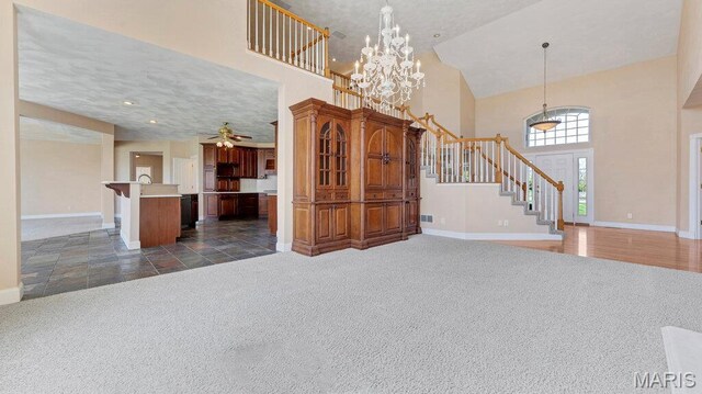 9108 Wiltshire Dr, Columbia, IL 62236 - entrance foyer featuring a towering ceiling, stairs, dark colored carpet, baseboards, and a chandelier