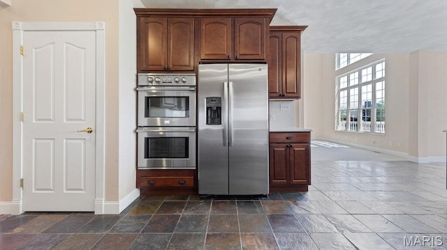 9108 Wiltshire Dr, Columbia, IL 62236 - kitchen with appliances with stainless steel finishes, stone tile flooring, and baseboards