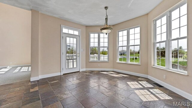 9108 Wiltshire Dr, Columbia, IL 62236 - unfurnished dining area featuring plenty of natural light, baseboards, and stone tile flooring