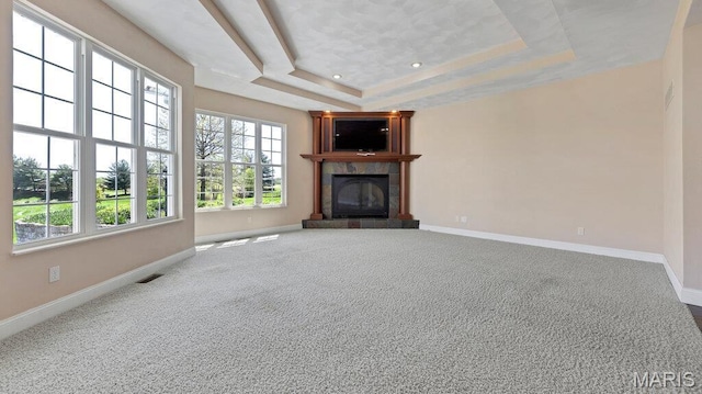 9108 Wiltshire Dr, Columbia, IL 62236 - unfurnished living room featuring a tray ceiling, a tiled fireplace, baseboards, and carpet