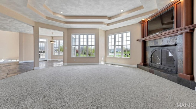 9108 Wiltshire Dr, Columbia, IL 62236 - unfurnished living room with baseboards, a fireplace, plenty of natural light, a tray ceiling, and recessed lighting