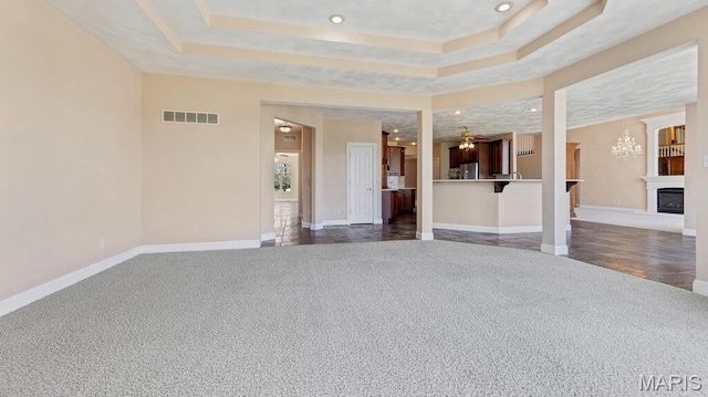 9108 Wiltshire Dr, Columbia, IL 62236 - unfurnished living room with carpet flooring, a chandelier, recessed lighting, a raised ceiling, and baseboards
