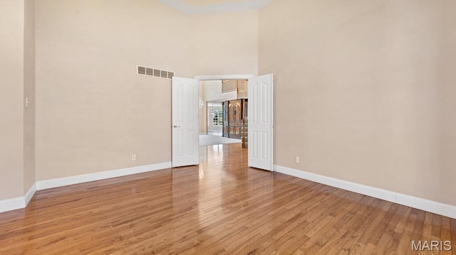 9108 Wiltshire Dr, Columbia, IL 62236 - spare room featuring light wood finished floors, baseboards, and a towering ceiling