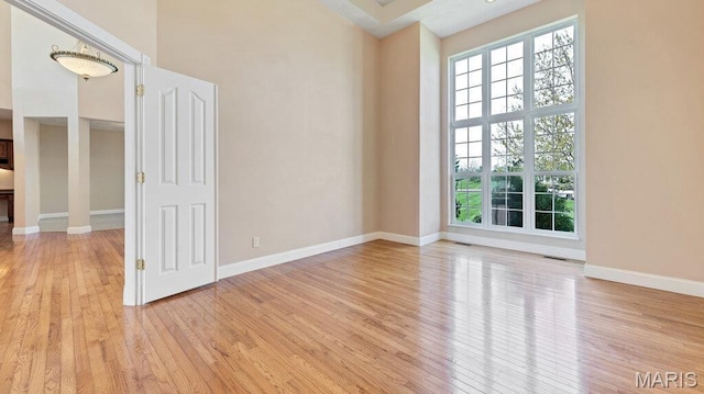 9108 Wiltshire Dr, Columbia, IL 62236 - unfurnished room with light wood-type flooring, baseboards, and a high ceiling