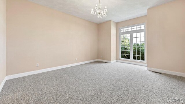 9108 Wiltshire Dr, Columbia, IL 62236 - carpeted empty room with baseboards and a chandelier