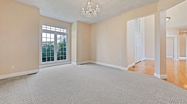 9108 Wiltshire Dr, Columbia, IL 62236 - empty room featuring a chandelier, baseboards, and wood finished floors