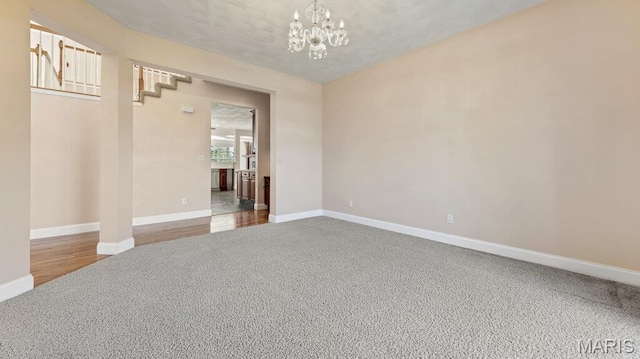 9108 Wiltshire Dr, Columbia, IL 62236 - carpeted empty room featuring baseboards and a chandelier