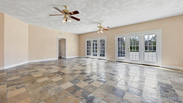 9108 Wiltshire Dr, Columbia, IL 62236 - spare room with french doors, a ceiling fan, stone tile flooring, and baseboards