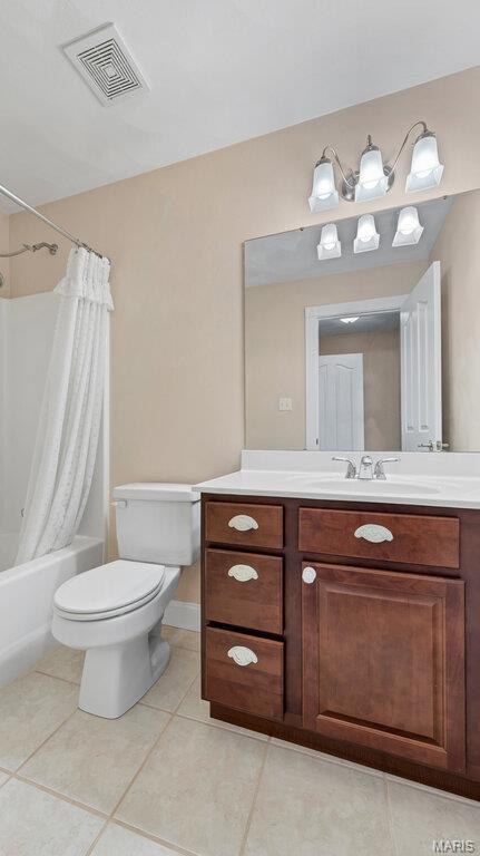 9108 Wiltshire Dr, Columbia, IL 62236 - bathroom with toilet, tile patterned floors, vanity, and shower / bathtub combination with curtain