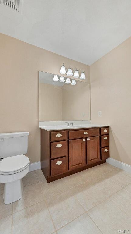 9108 Wiltshire Dr, Columbia, IL 62236 - half bathroom with baseboards, vanity, toilet, and tile patterned flooring
