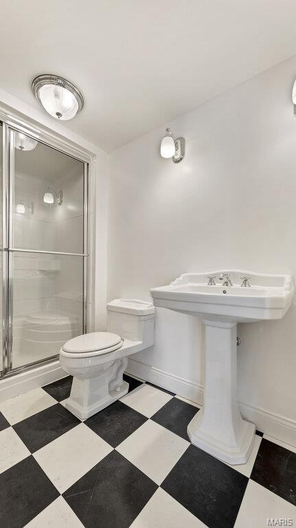 9108 Wiltshire Dr, Columbia, IL 62236 - full bath with a shower stall, toilet, tile patterned floors, and baseboards