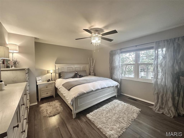 bedroom with baseboards, dark wood finished floors, and a ceiling fan