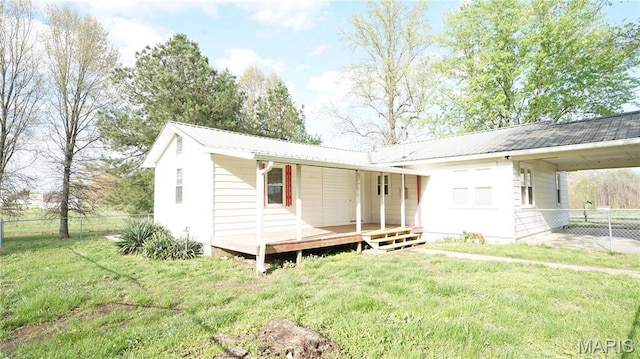 rear view of property featuring metal roof and an attached carport