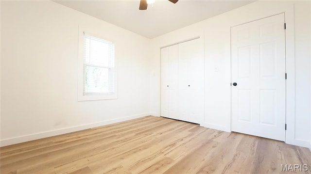 unfurnished bedroom with baseboards, light wood finished floors, a closet, and a ceiling fan