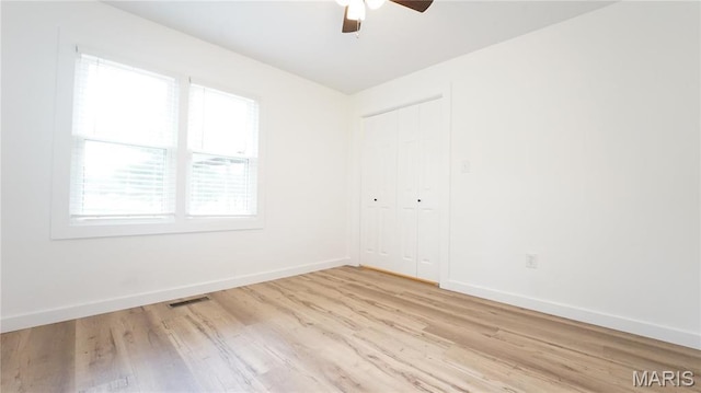 unfurnished room featuring ceiling fan, baseboards, and wood finished floors