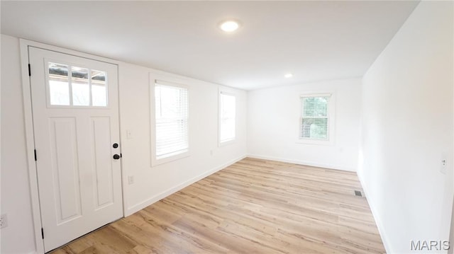 entryway featuring light wood-type flooring, baseboards, and recessed lighting