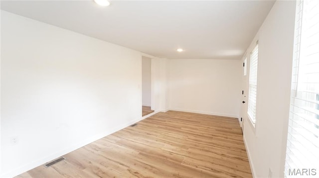 spare room with light wood-style flooring, baseboards, and recessed lighting