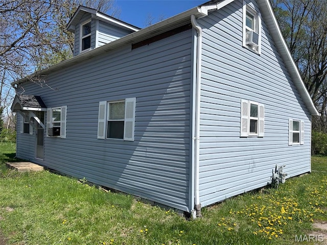 view of home's exterior with a yard