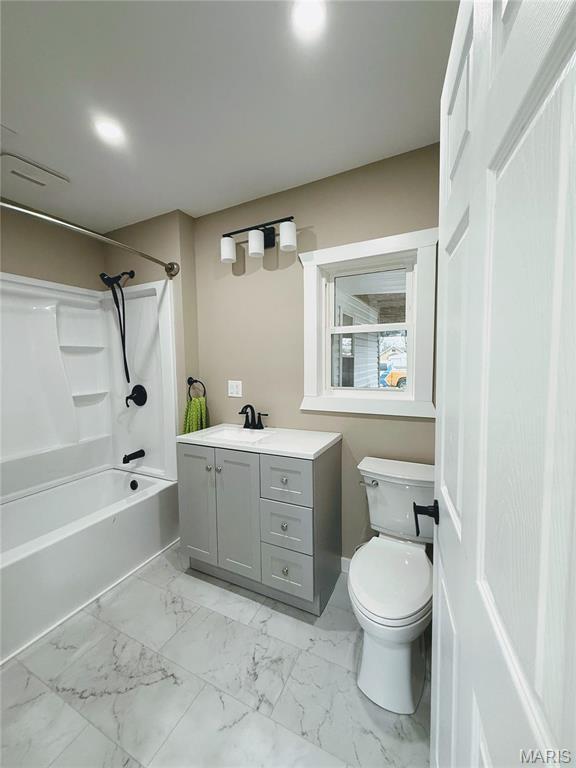 120 W Caldwell, La Plata, MO 63549 - bathroom featuring washtub / shower combination, vanity, and marble finish flooring