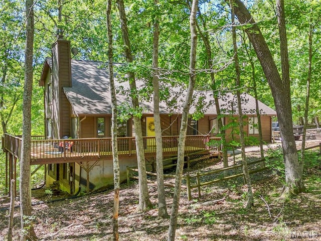 5 Cedar Fork Ct, Defiance, MO 63341 - back of property featuring a deck, a shingled roof, and a chimney