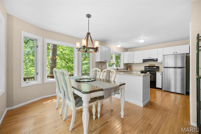 5 Cedar Fork Ct, Defiance, MO 63341 - dining space with a chandelier, baseboards, and light wood-type flooring