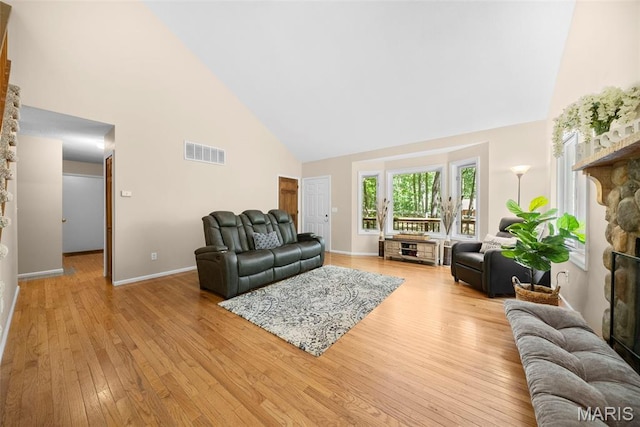 5 Cedar Fork Ct, Defiance, MO 63341 - living room with high vaulted ceiling, light wood-style floors, and baseboards