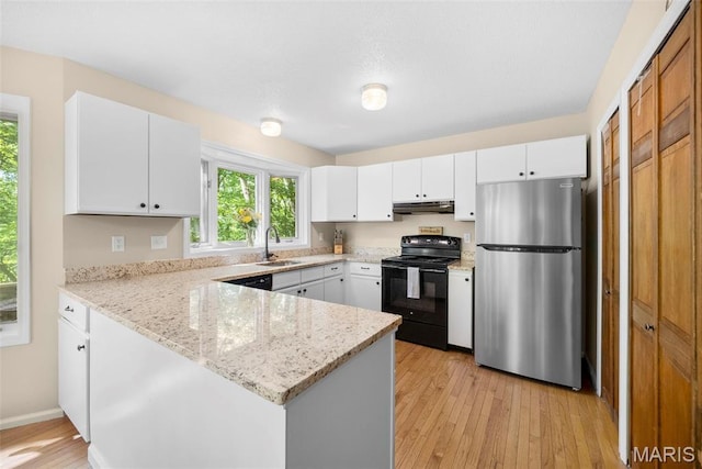 5 Cedar Fork Ct, Defiance, MO 63341 - kitchen with freestanding refrigerator, black electric range oven, under cabinet range hood, a peninsula, and light wood-style flooring