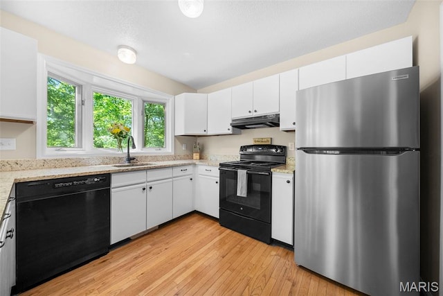 5 Cedar Fork Ct, Defiance, MO 63341 - kitchen featuring black appliances, a sink, under cabinet range hood, light wood finished floors, and white cabinets