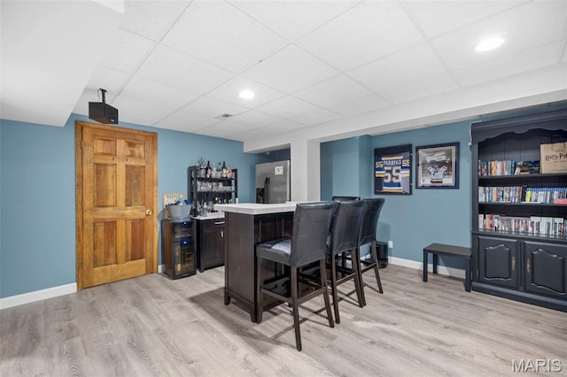 5 Cedar Fork Ct, Defiance, MO 63341 - indoor dry bar with stainless steel refrigerator with ice dispenser, light wood-style floors, baseboards, a paneled ceiling, and recessed lighting