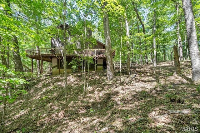 5 Cedar Fork Ct, Defiance, MO 63341 - rear view of house with a deck and a wooded view
