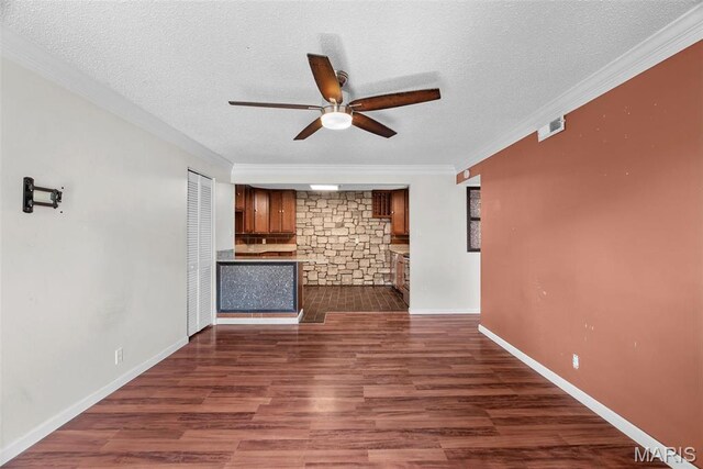 2793 Blackforest Dr Unit B, Saint Louis, MO 63129 - unfurnished living room featuring ceiling fan, a textured ceiling, crown molding, dark wood-style floors, and a fireplace