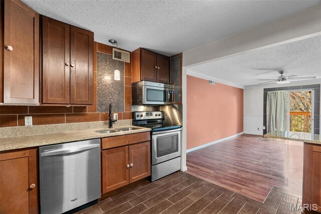 2793 Blackforest Dr Unit B, Saint Louis, MO 63129 - kitchen featuring appliances with stainless steel finishes, a textured ceiling, a sink, a ceiling fan, and dark wood-style floors