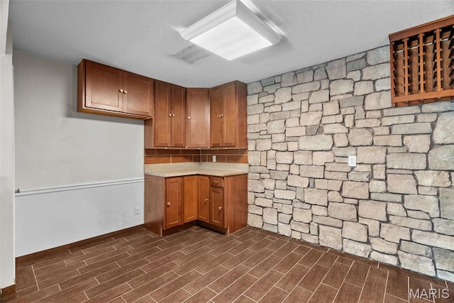 2793 Blackforest Dr Unit B, Saint Louis, MO 63129 - kitchen with dark wood-type flooring, light countertops, and brown cabinetry