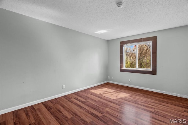 2793 Blackforest Dr Unit B, Saint Louis, MO 63129 - empty room featuring wood finished floors, baseboards, a textured ceiling, and a smoke detector