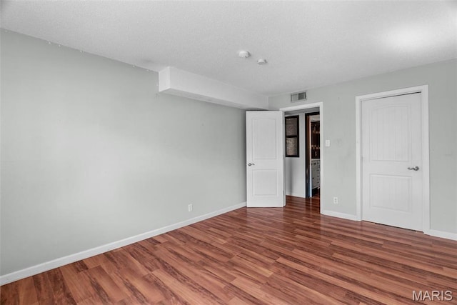 2793 Blackforest Dr Unit B, Saint Louis, MO 63129 - unfurnished bedroom with wood finished floors, baseboards, and a textured ceiling