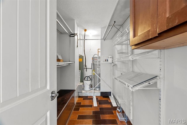 2793 Blackforest Dr Unit B, Saint Louis, MO 63129 - laundry room featuring dark wood-style flooring and strapped water heater
