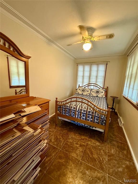 6542 Cedar Hill Rd, Cedar Hill, MO 63016 - bedroom featuring ornamental molding, dark tile patterned floors, baseboards, and a ceiling fan