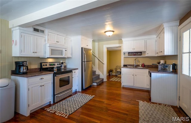 4 Lafayette St, Washington, MO 63090 - kitchen with appliances with stainless steel finishes, dark countertops, and white cabinetry