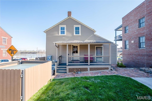 4 Lafayette St, Washington, MO 63090 - rear view of house featuring a chimney and covered porch