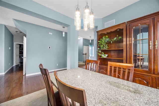 77 Brighton Park Dr, Saint Charles, MO 63303 - dining room with wood finished floors, a chandelier, and baseboards